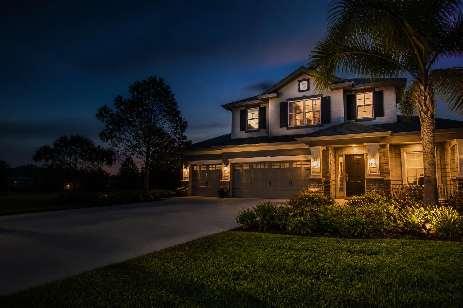 Florida home at dusk with warm interior lighting